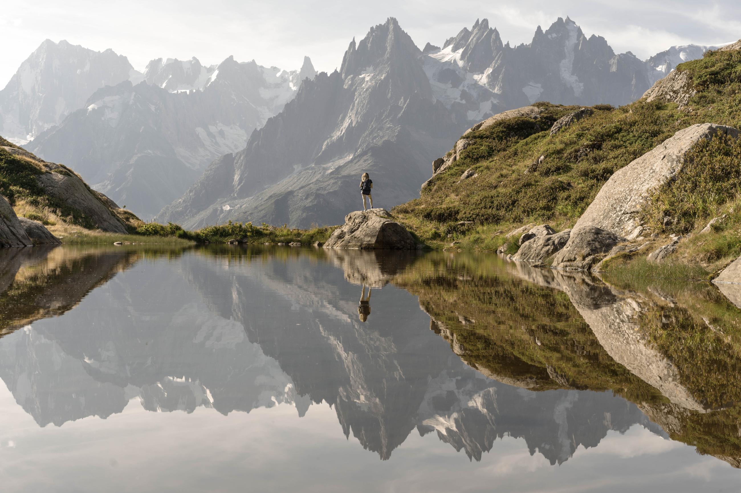 Mountain view with woman standing in distance